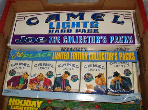 Vintage Camel Racing package includes a rare Camel Racing 75th Birthday poster (12'x24') missing the surgeon general warning, a Smokin' Joe's Racing tin with matches and ash tray, 3 vintage Camel GT racing passes, a Smokin' Joe's cigarette pack dispenser in the shape of a car, and 4 Camel Joe champions pins. A value of over $75 for $45!